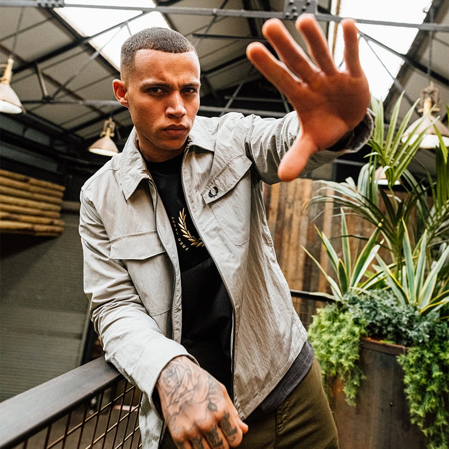 A man posing for a picture in Fred Perry clothes