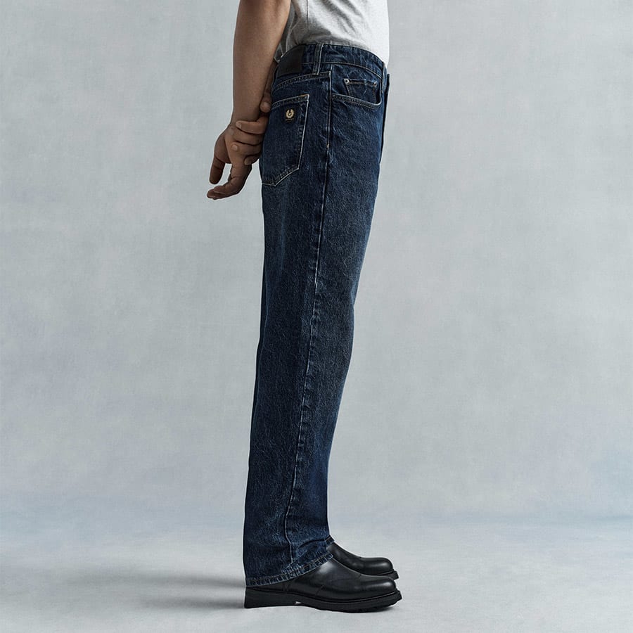 A side view of a man wearing Belstaff jeans