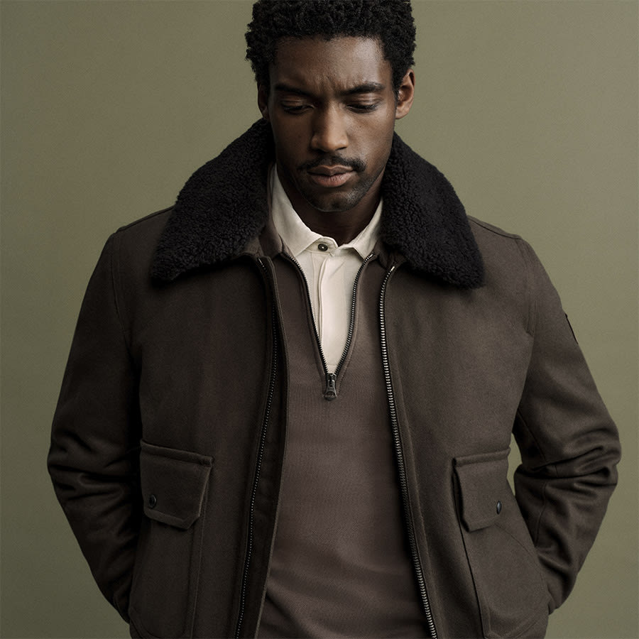 A man wearing a Belstaff jacket looks down