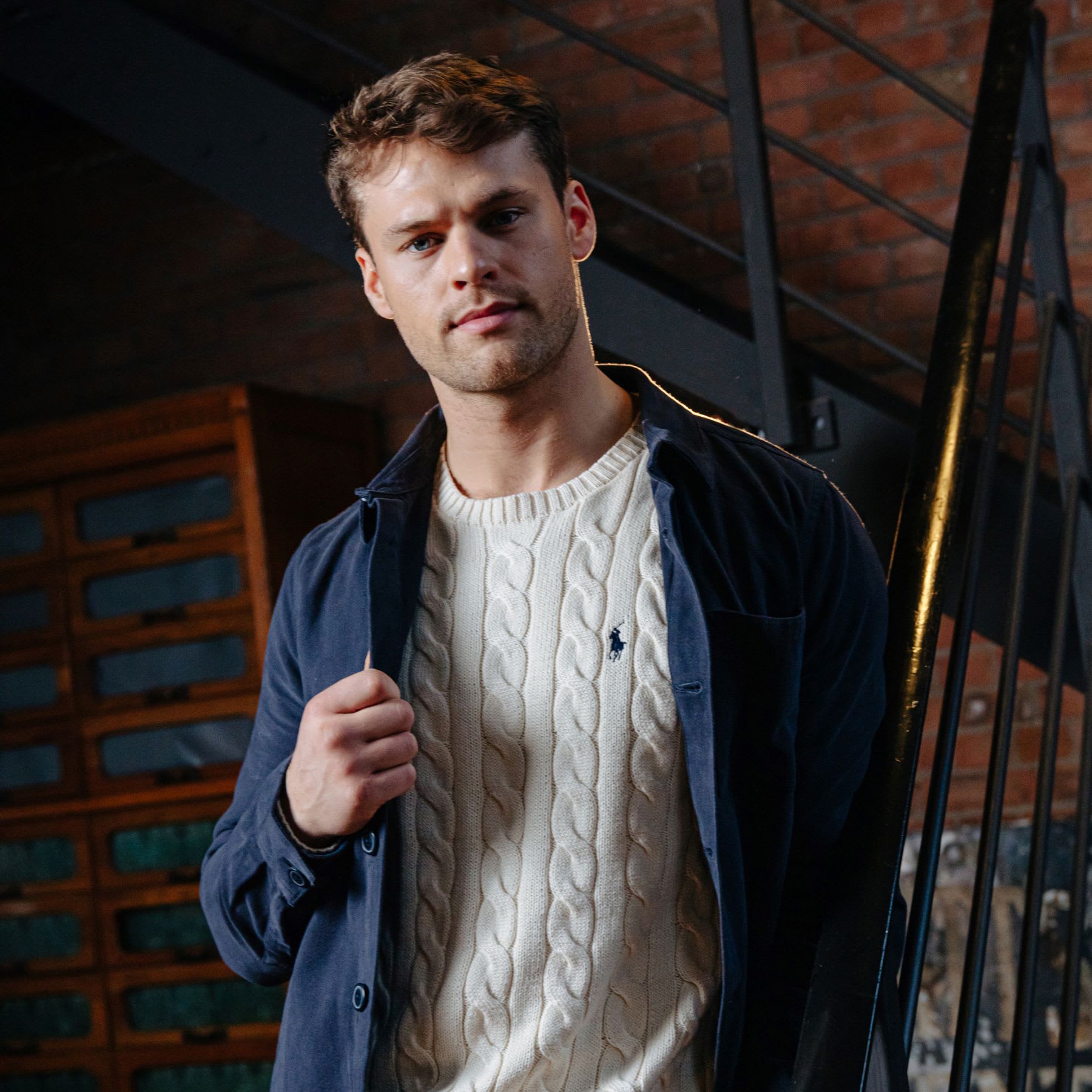 Man modelling a Ralph Lauren knitted jumper and lightweight jacket