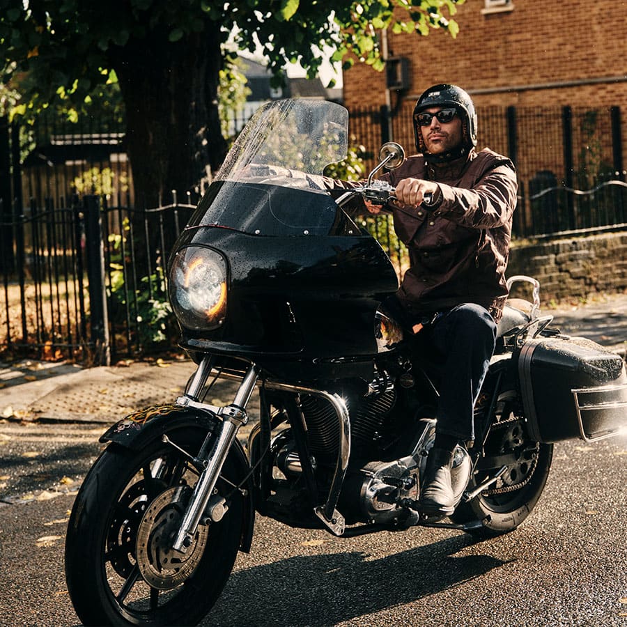 Elliot on a motorbike wearing Belstaff