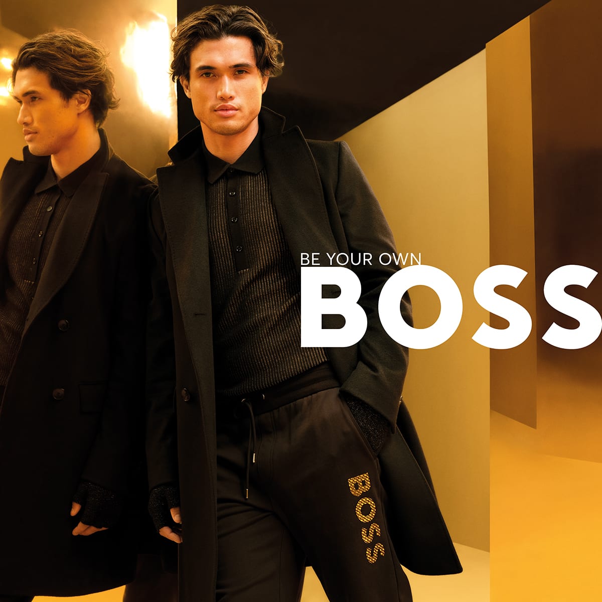 A man leaning wearing BOSS clothing