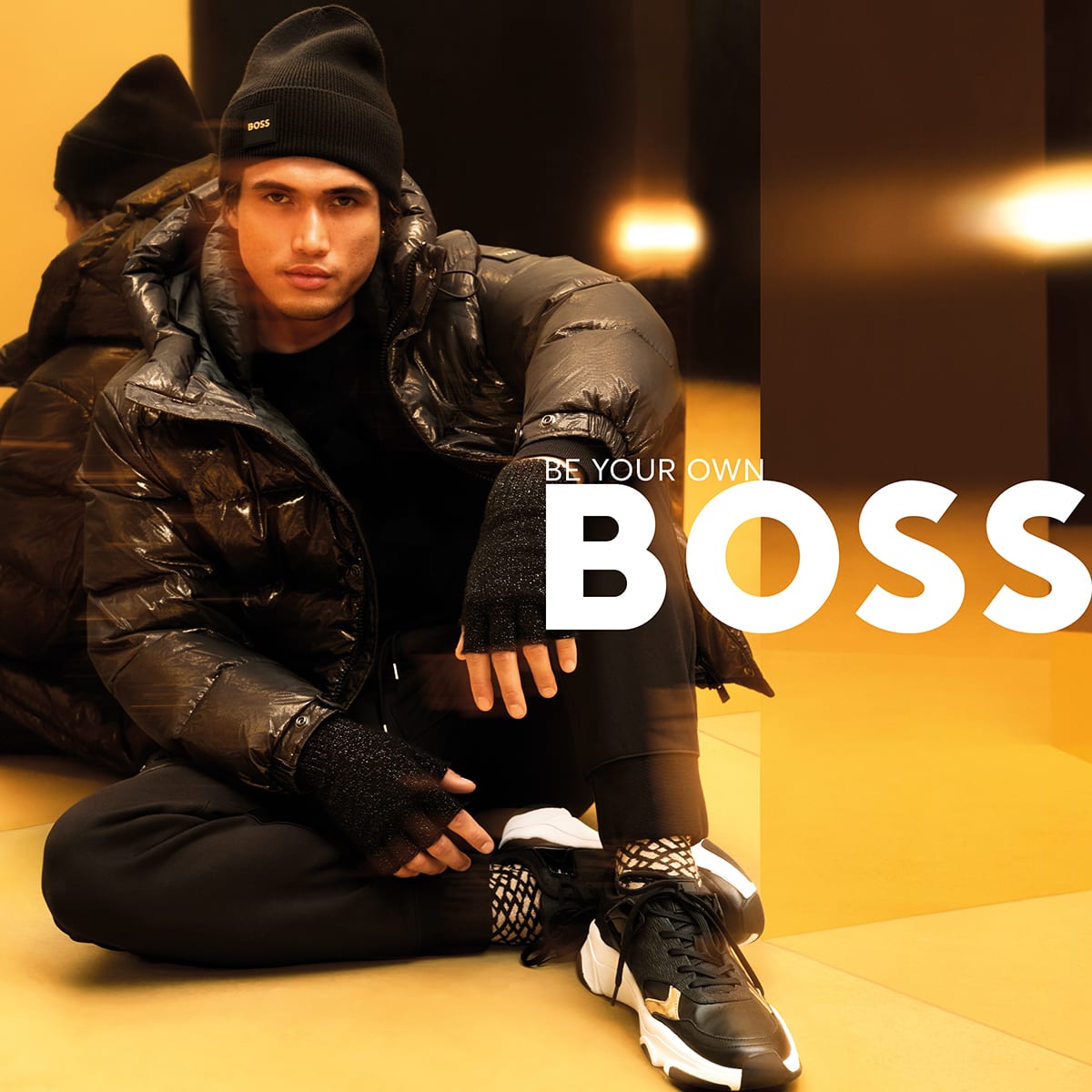 A man sitting down wearing BOSS clothing