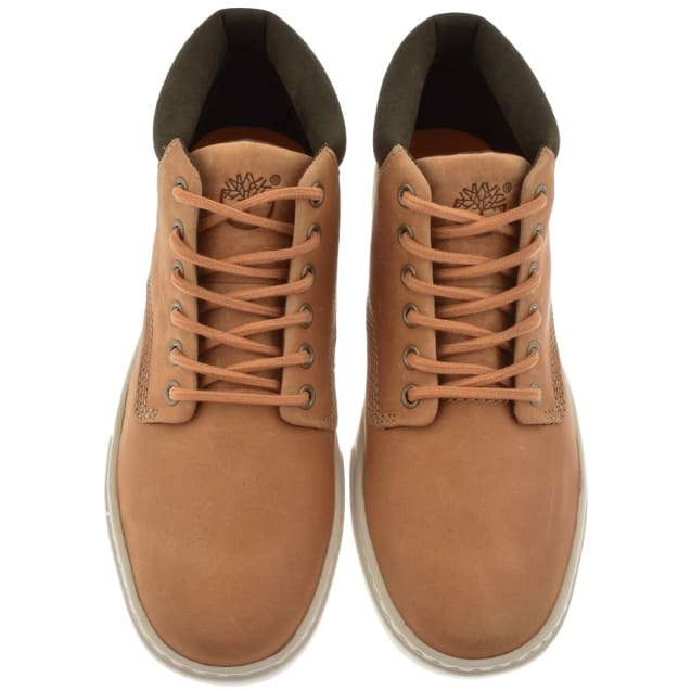A pair of Timberland boots with crossed lacing.
