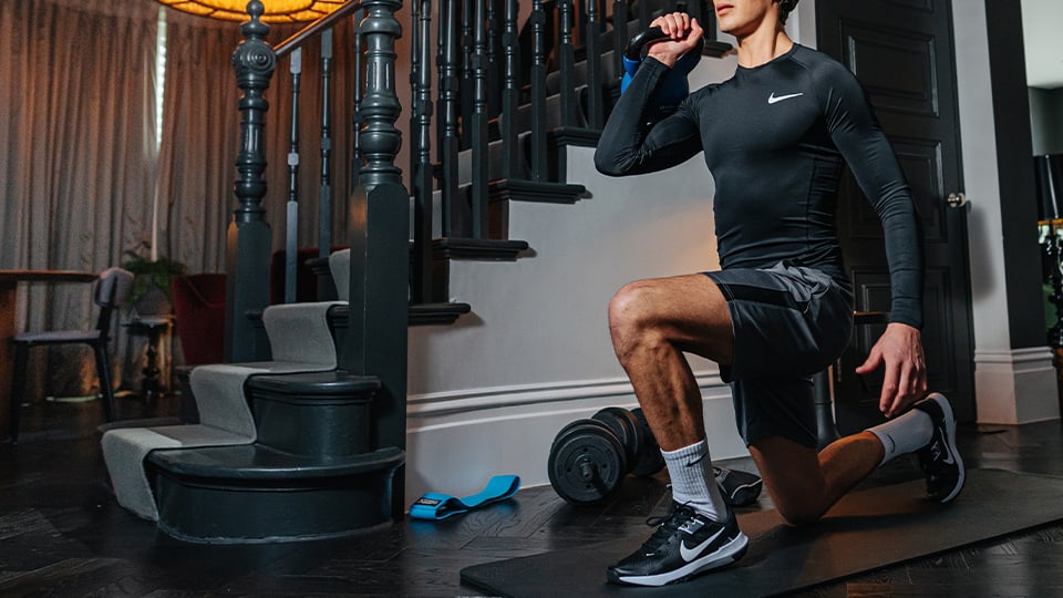 A man working out at home in gym clothes