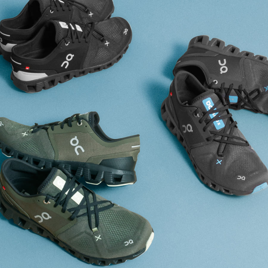 A selection of trainers by On Running in green and black.