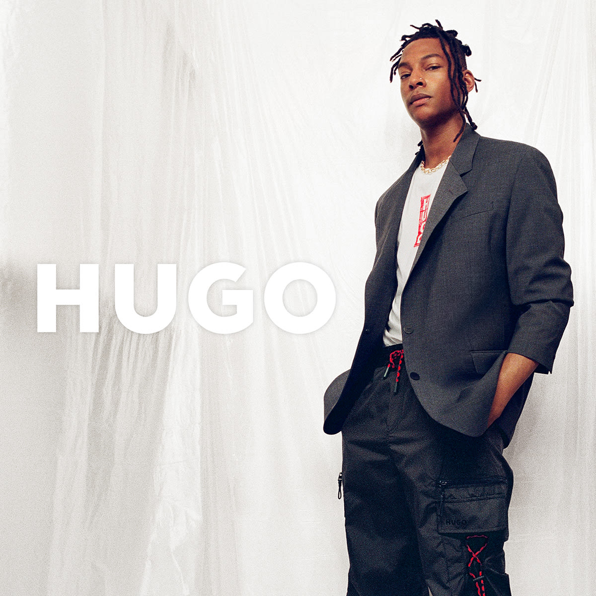 A man dressed in a HUGO jacket and trousers