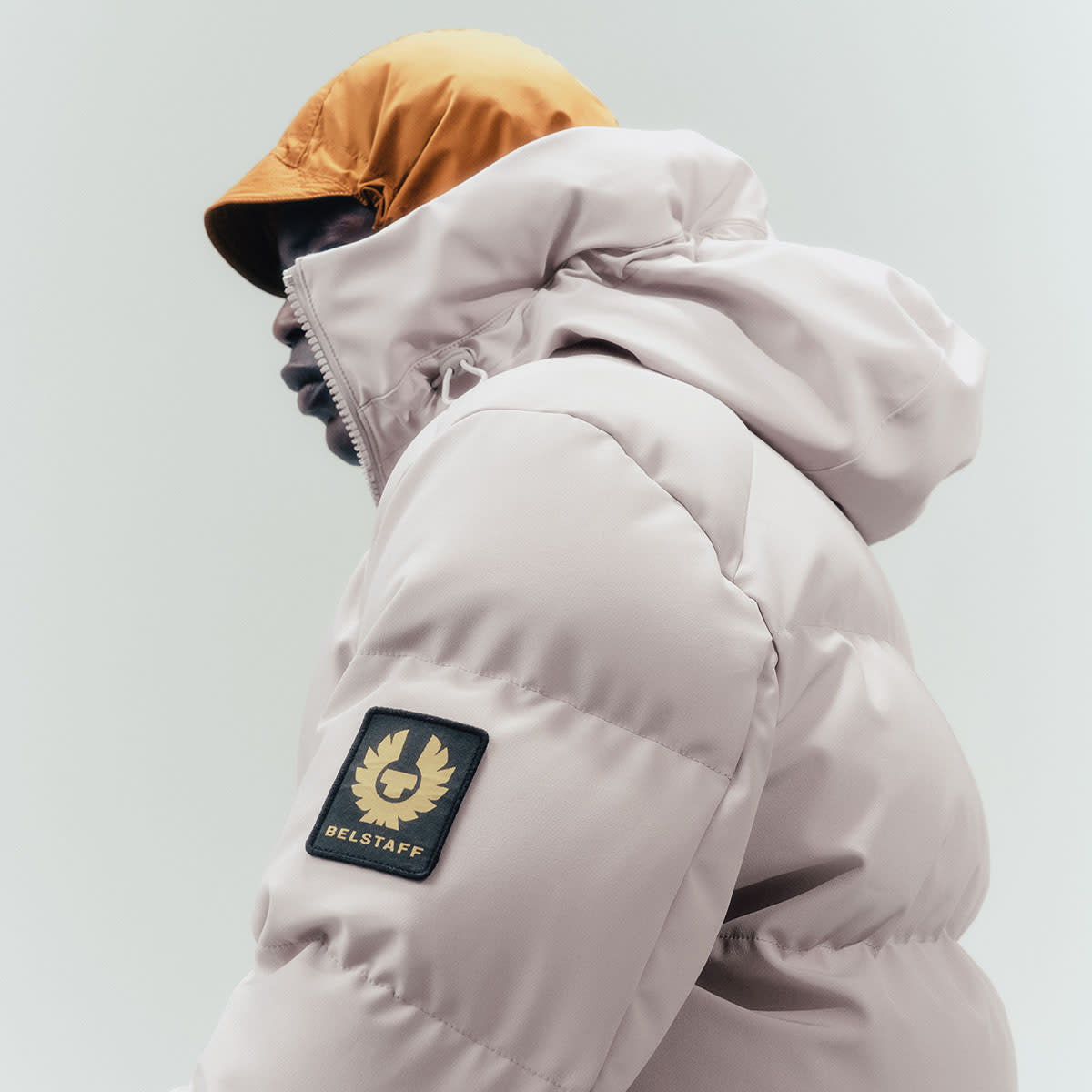 A man wearing a cream-coloured Belstaff jacket