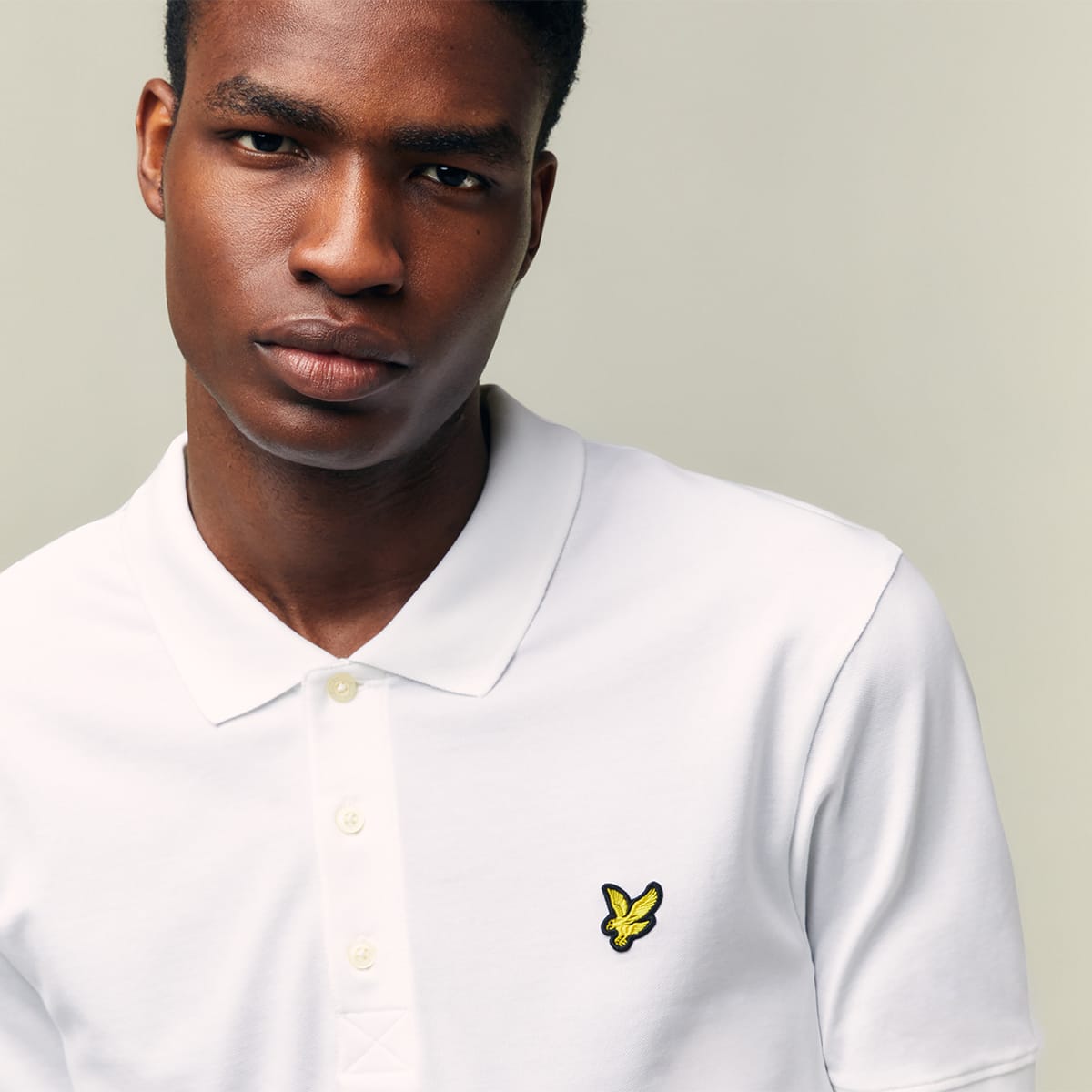 A man dressed in a white Lyle and Scott shirt