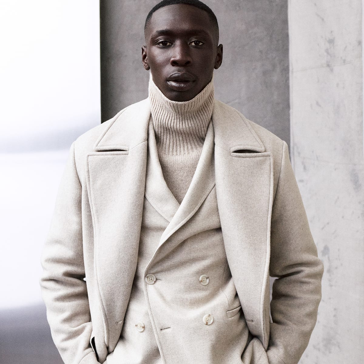 A man wearing a beige BOSS outfit