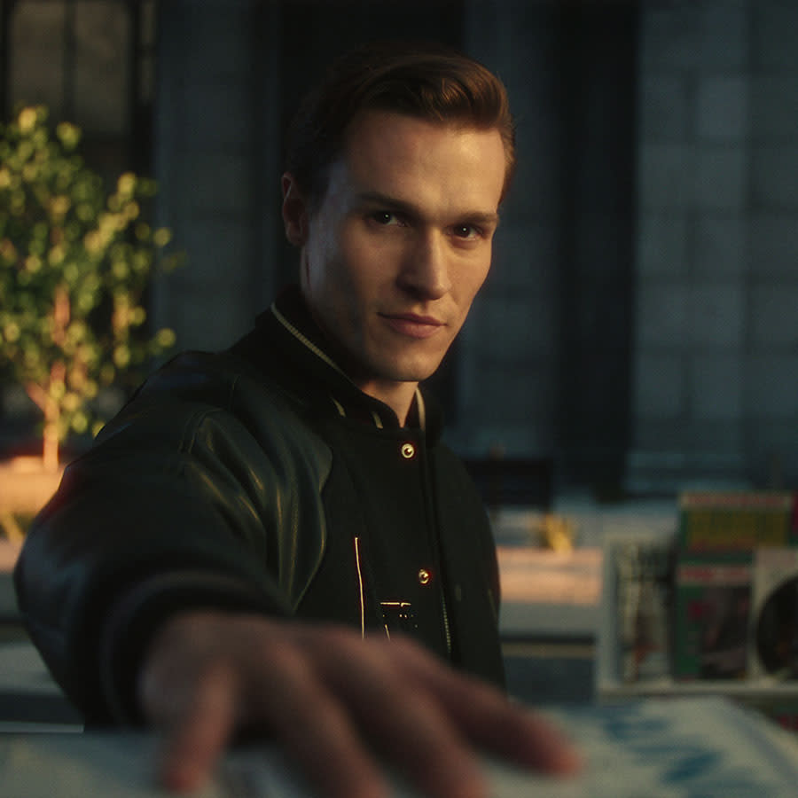 A man passing a Mainline Menswear parcel towards the camera