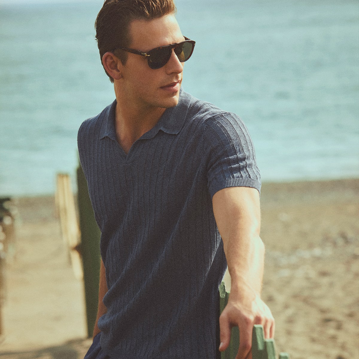 A man by the sea wearing Paul and Shark