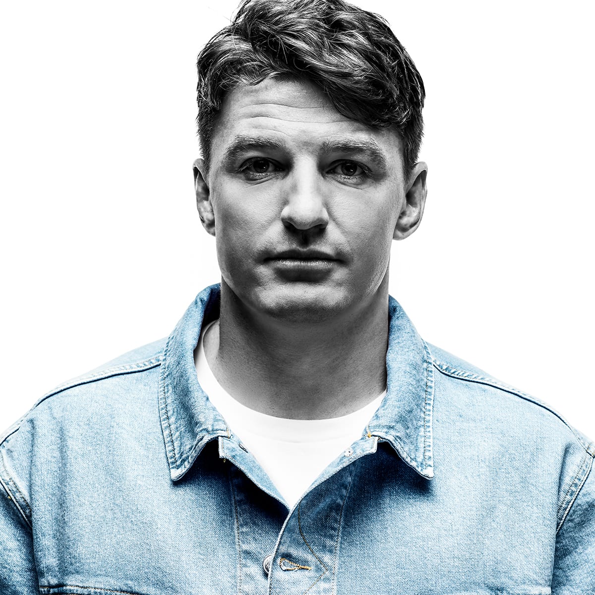 A close up of a man wearing a Replay denim shirt