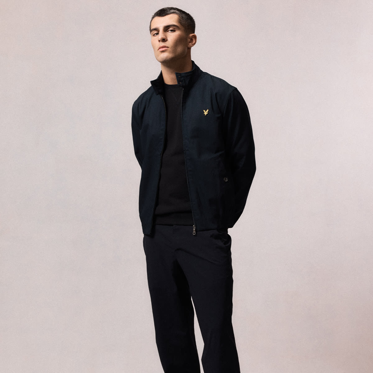 A full length shot of a man dressed in Lyle & Scott