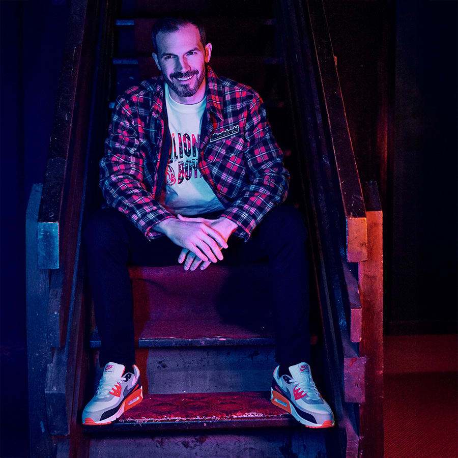 A happy man sitting on some stairs