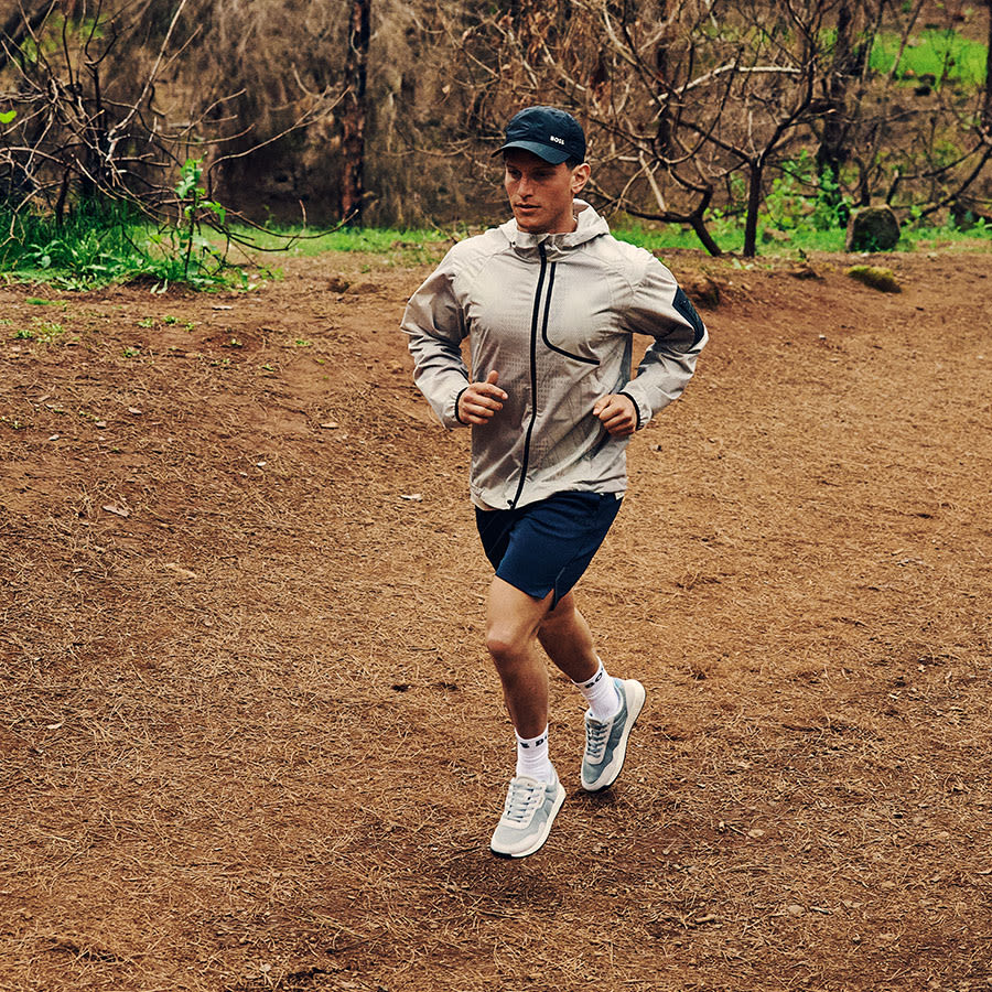 A man trail running in the sunshine