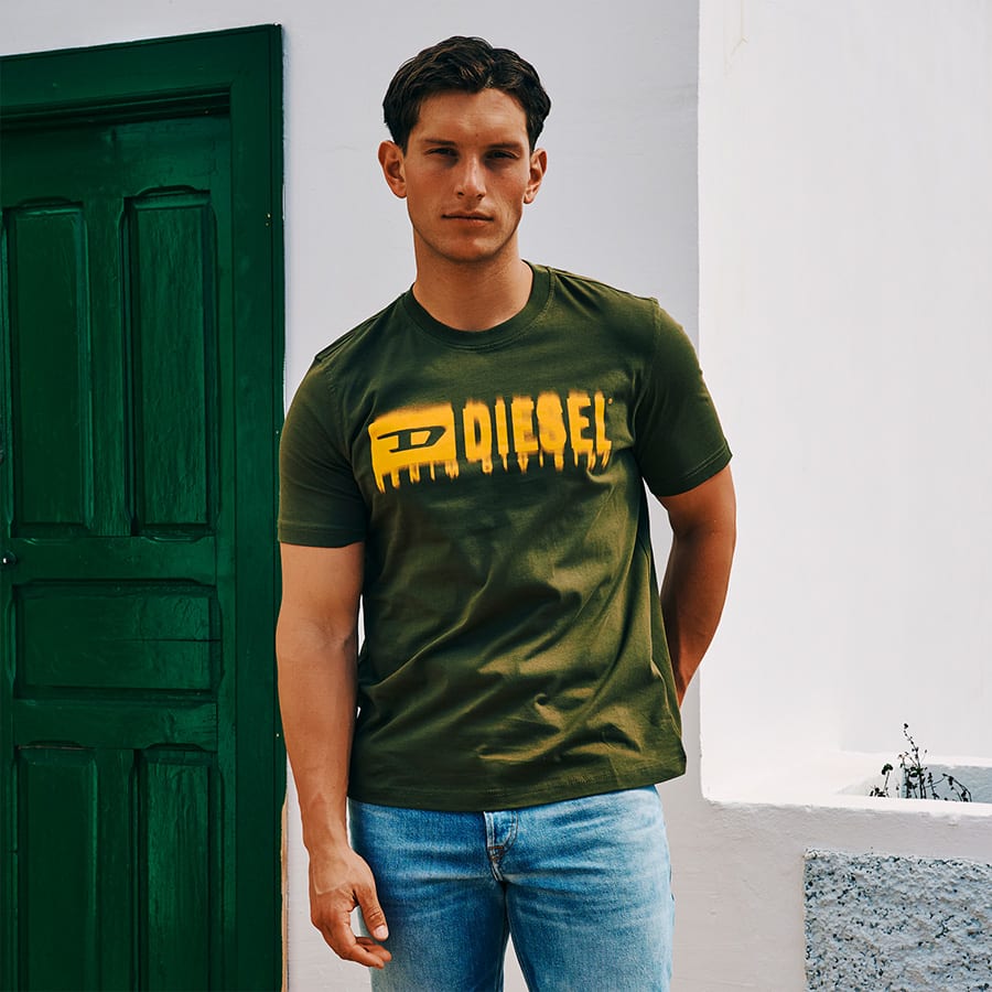 A man wearing a green Diesel T-shirt