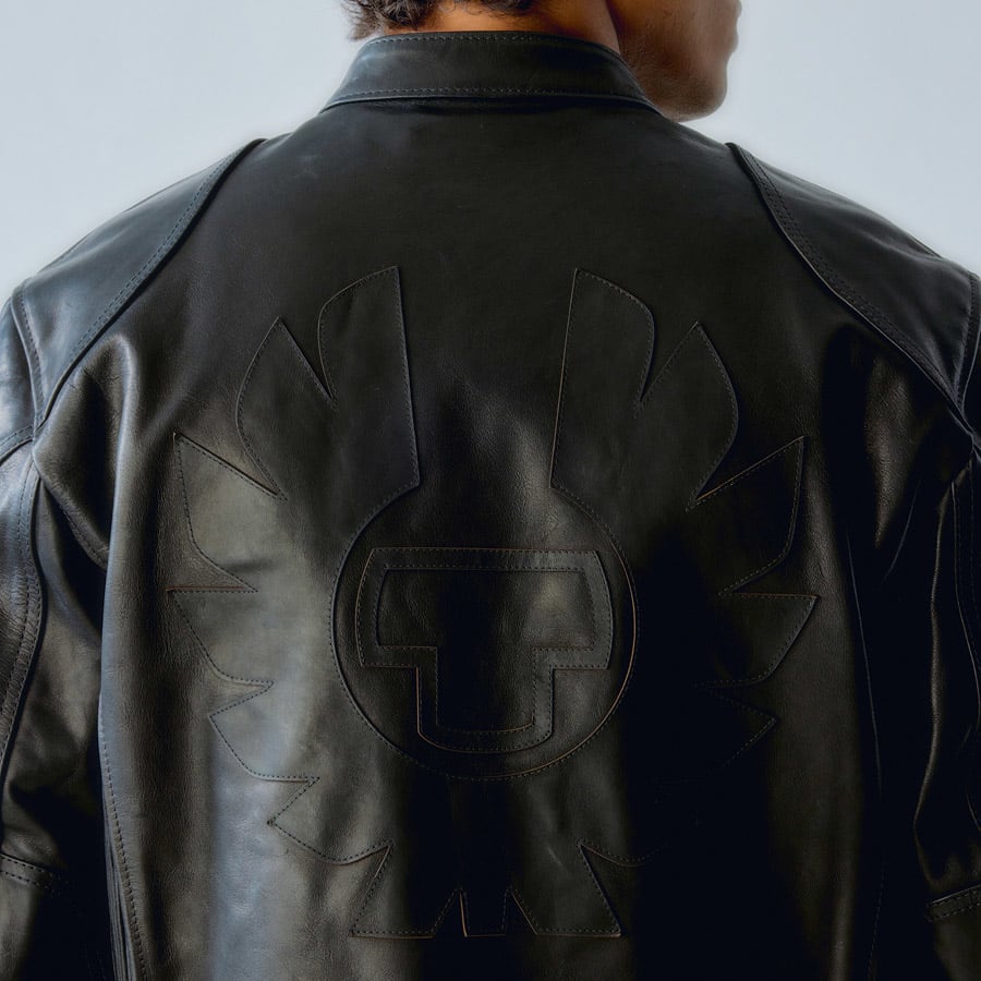 A man facing away from the camera wearing a Belstaff leather jacket