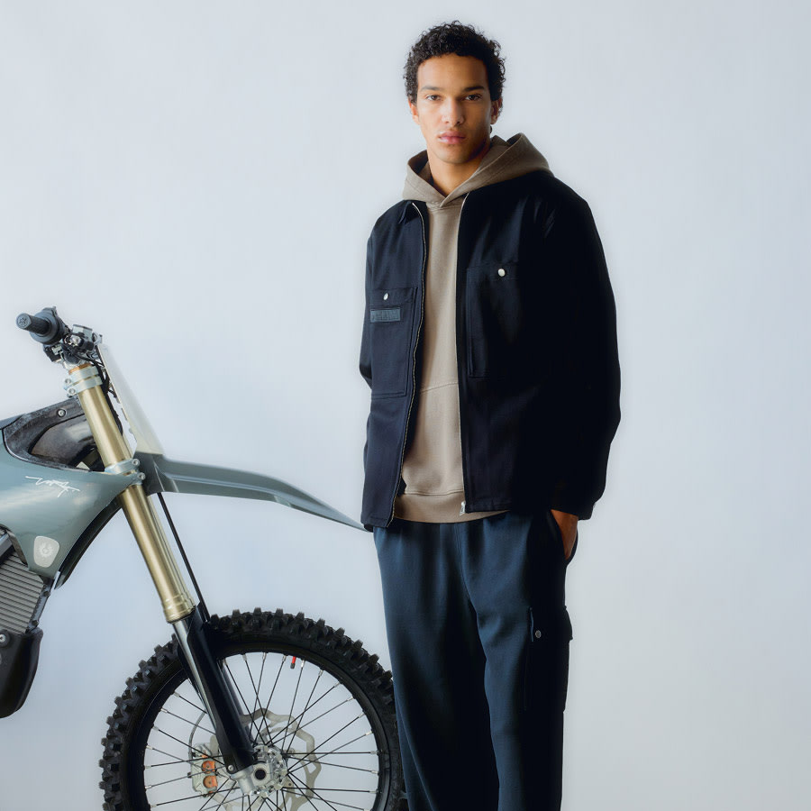 A man with a motorbike wearing Belstaff clothes