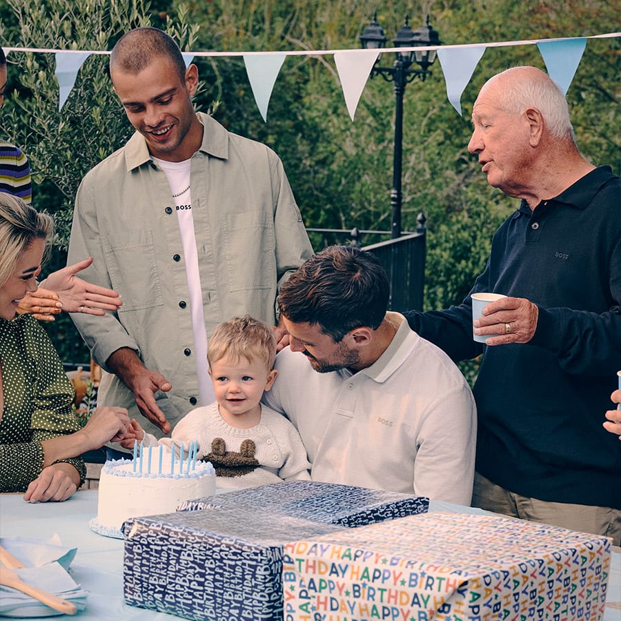 A family gather outside with gifts
