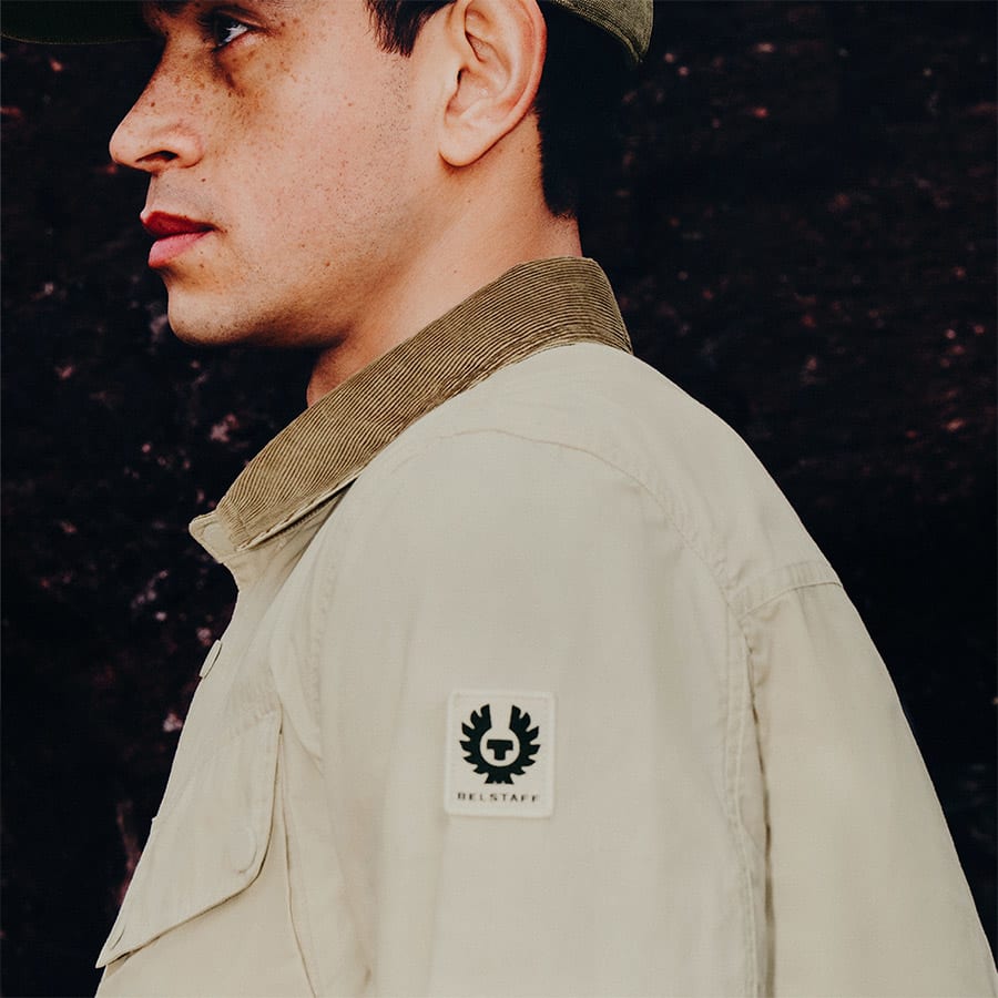A man wearing a Belstaff jacket looking to the left