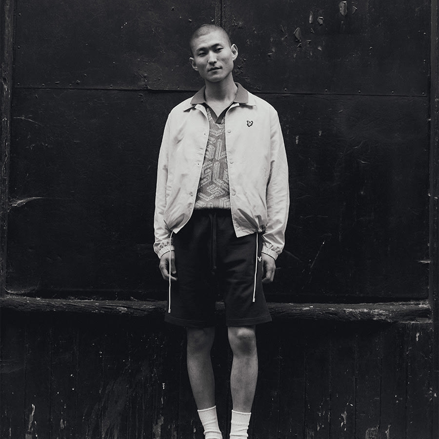 A black and white image of a man wearing Lyle & Scott