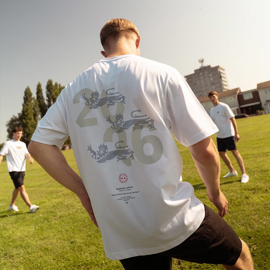 A man playing football in Marshall Artist clothes