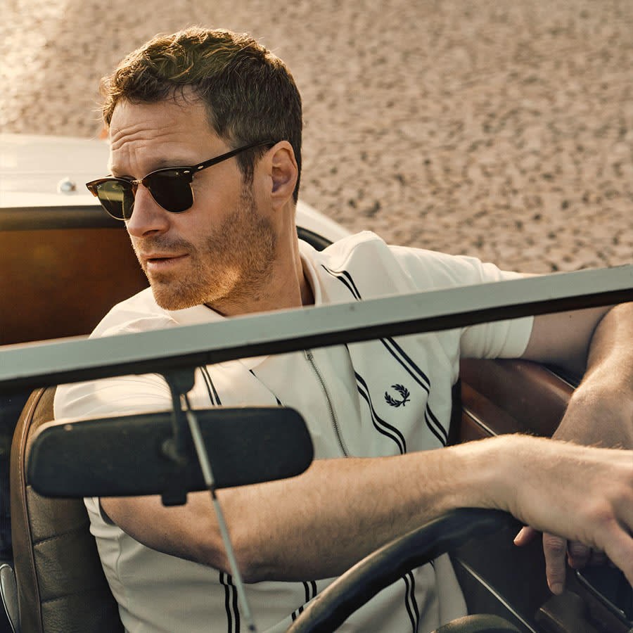 A man behind the wheel of a car