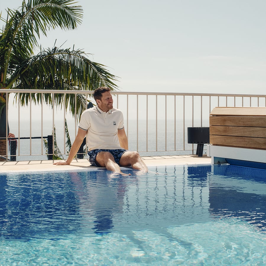 A man is relaxing by the swimming pool