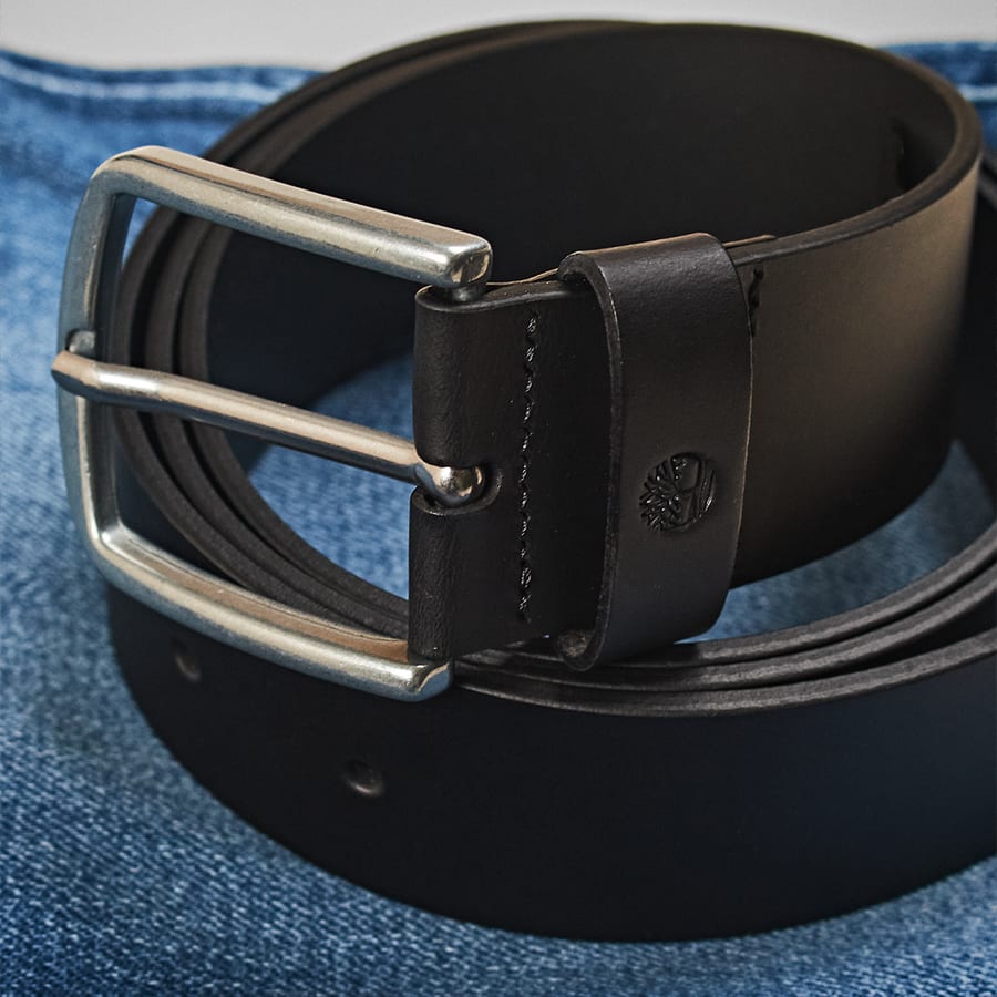 A leather belt with a silver coloured buckle
