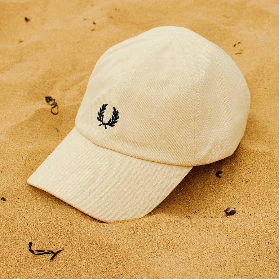 A Fred Perry Cap on the beach