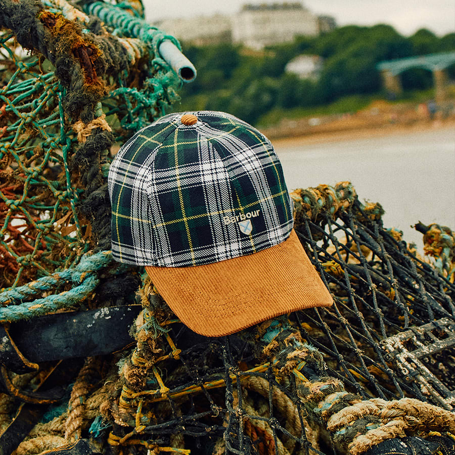 A Barbour baseball cap placed on some lobster pots