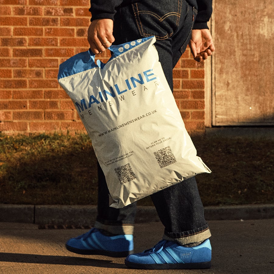 A man carrying a Mainline branded bag