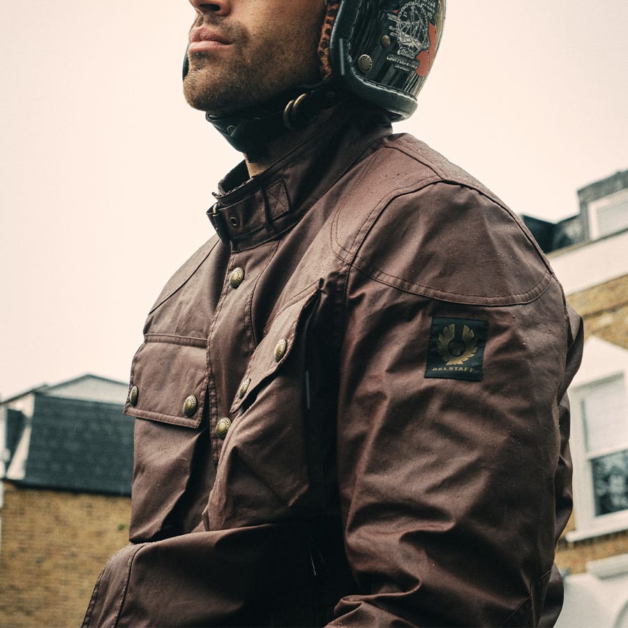 A man in a oxblood Belstaff Racemaster jacket